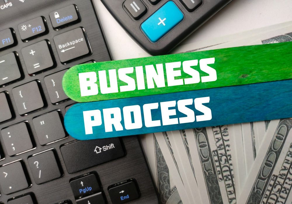 Keyboard,calculator and banknotes with the word BUSINESS PROCESS